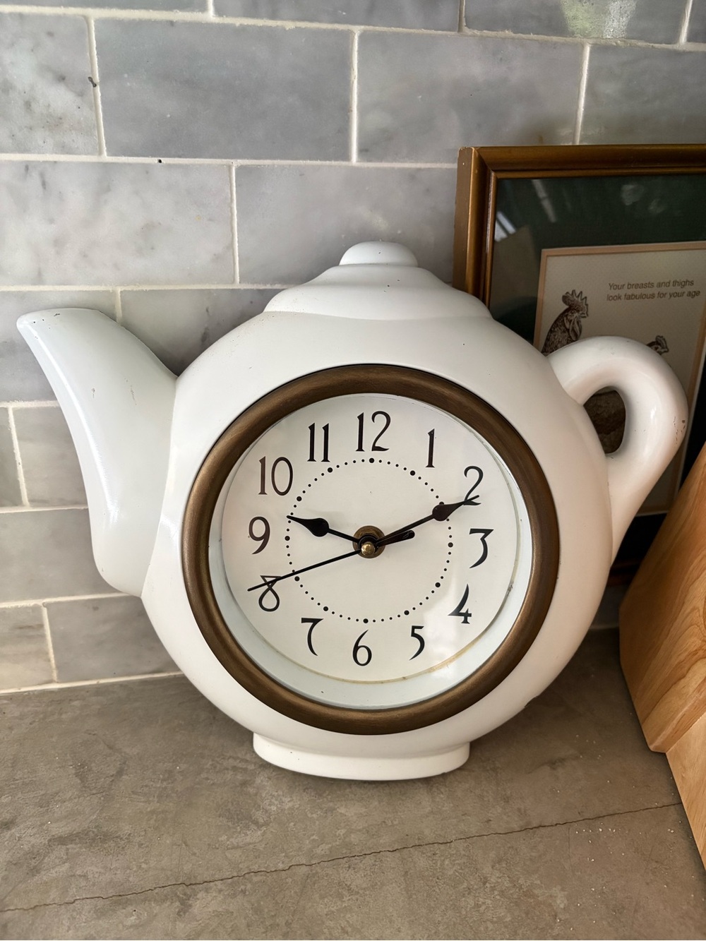 vintage teapot clock styled with a glossy white finish to look like ceramic.